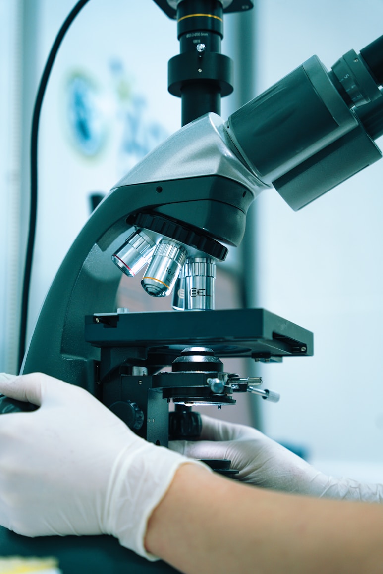 Researcher at a microscope